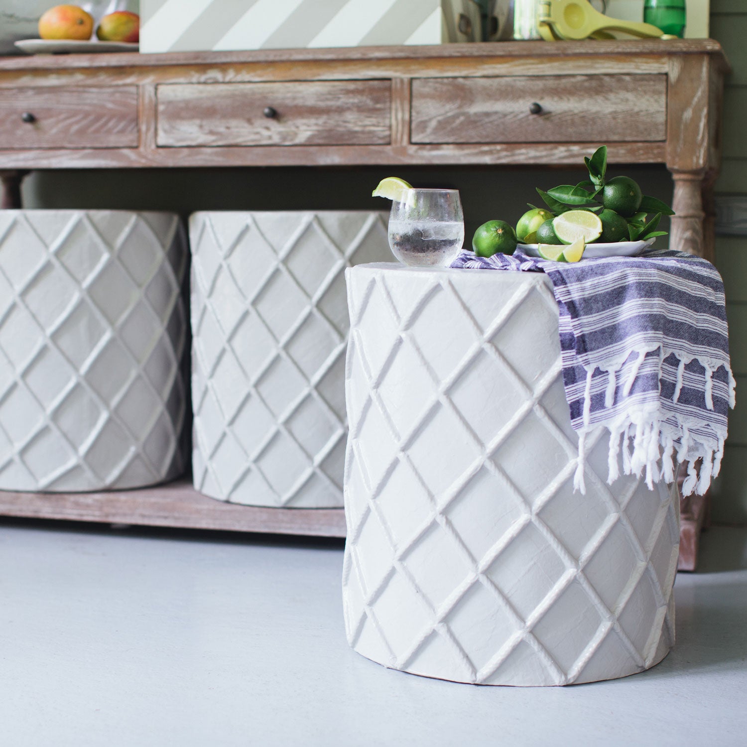 stylish stool/accent table clad in papier mache on porch